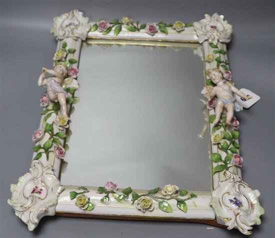 A 19th century Continental cherub and floral encrusted porcelain dressing mirror, height 43cm